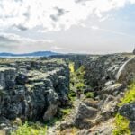 People walk through the Continental Rift in Thingvellir, Iceland