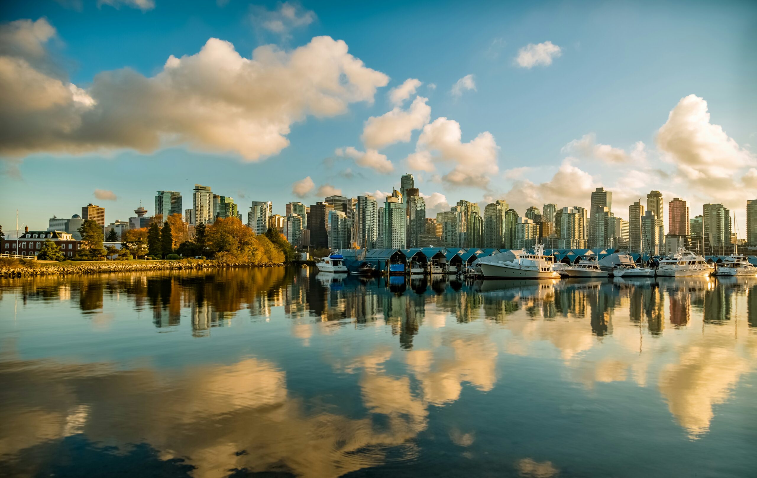 The Vancouver skyline is reflected in the water